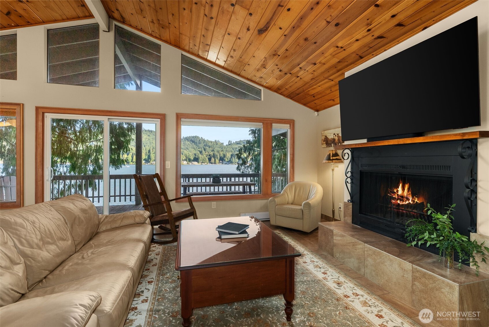 2147 Summit Lake Shore Road Northwest Olympia, WA 98502 - Photo 16 of 38 a living room with furniture a flat screen tv and a fireplace