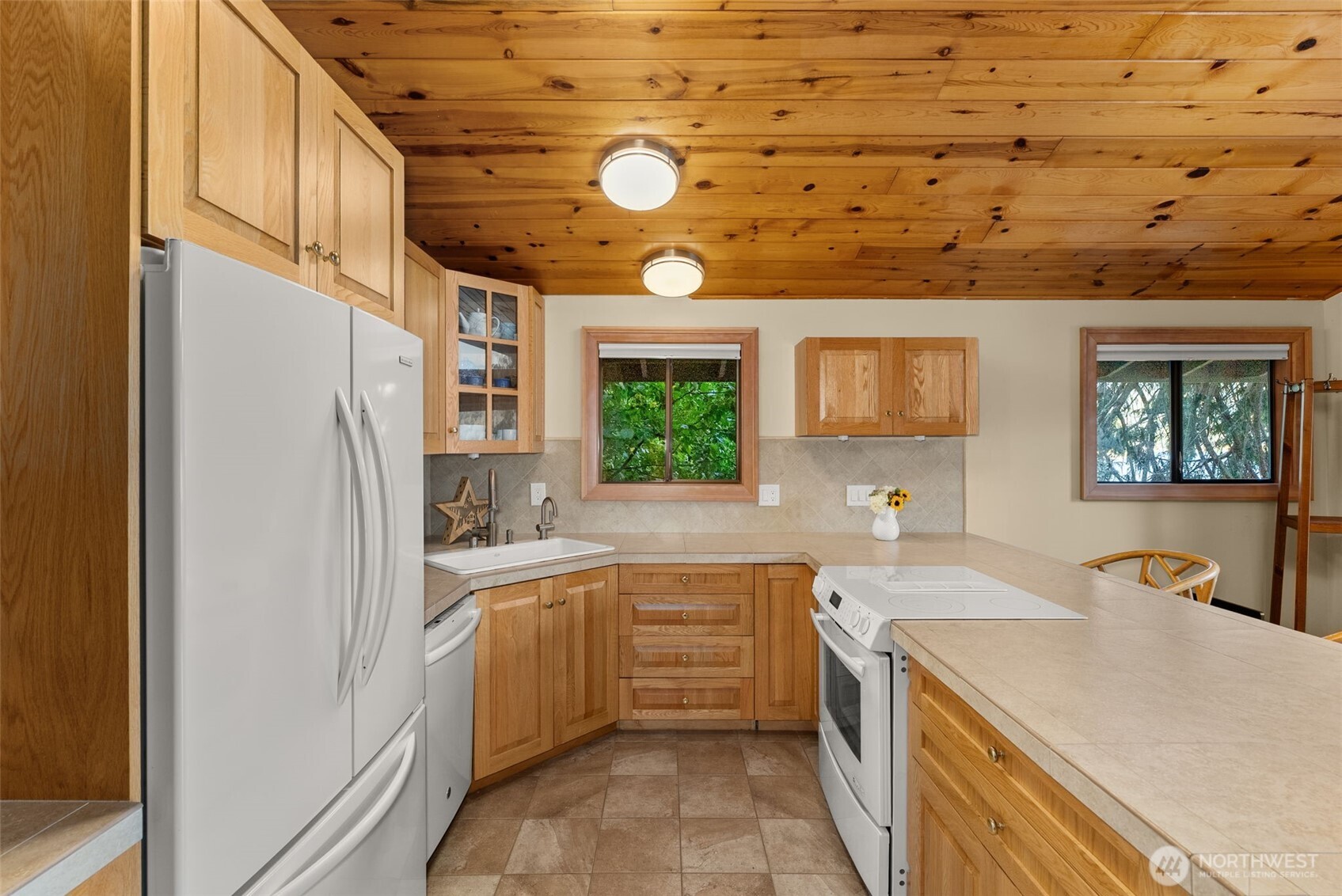 2147 Summit Lake Shore Road Northwest Olympia, WA 98502 - Photo 20 of 38 a kitchen with a sink refrigerator and window