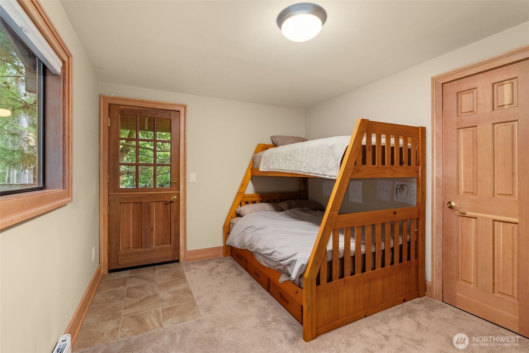 2147 Summit Lake Shore Road Northwest Olympia, WA 98502 - Photo 26 of 38 a bed sitting in a bedroom next to a window
