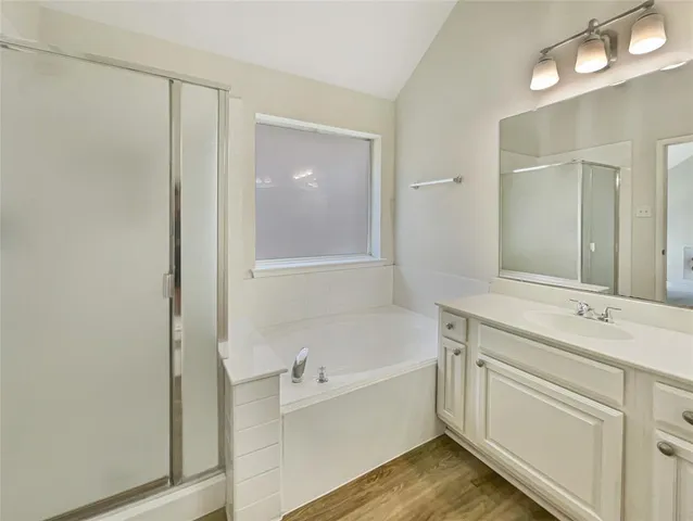 a bathroom with a tub sink and mirror