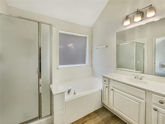 a bathroom with a bathtub a sink and a mirror