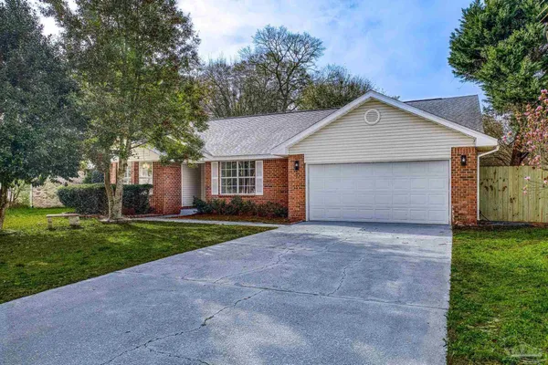 a view of a house with yard and a garden