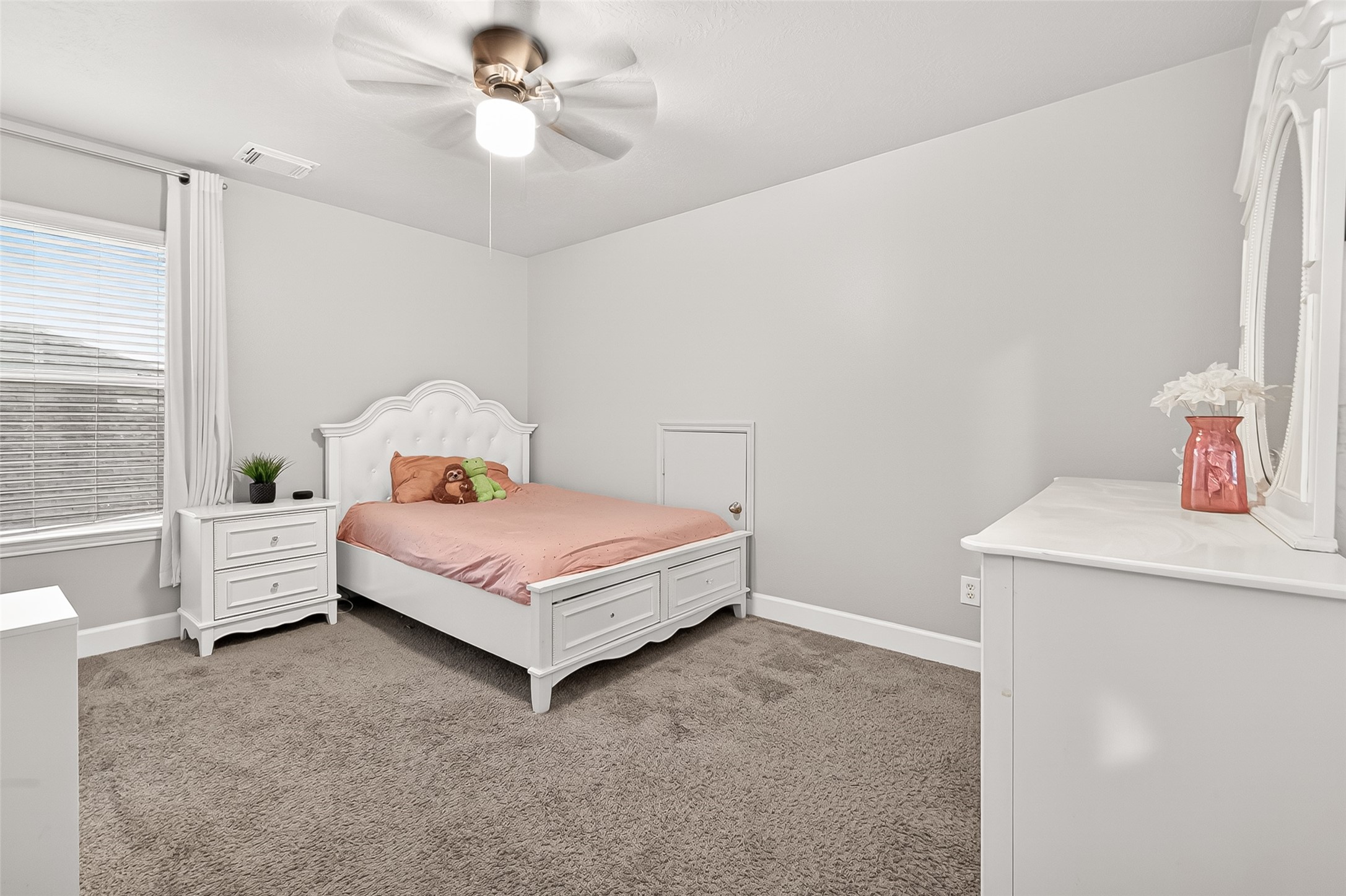 7415 Riven Oaks Court Cypress, TX 77433 - Photo 37 of 42 Bright and spacious secondary bedroom complete with a ceiling fan and plenty of room for relaxing, studying, or everyday living.