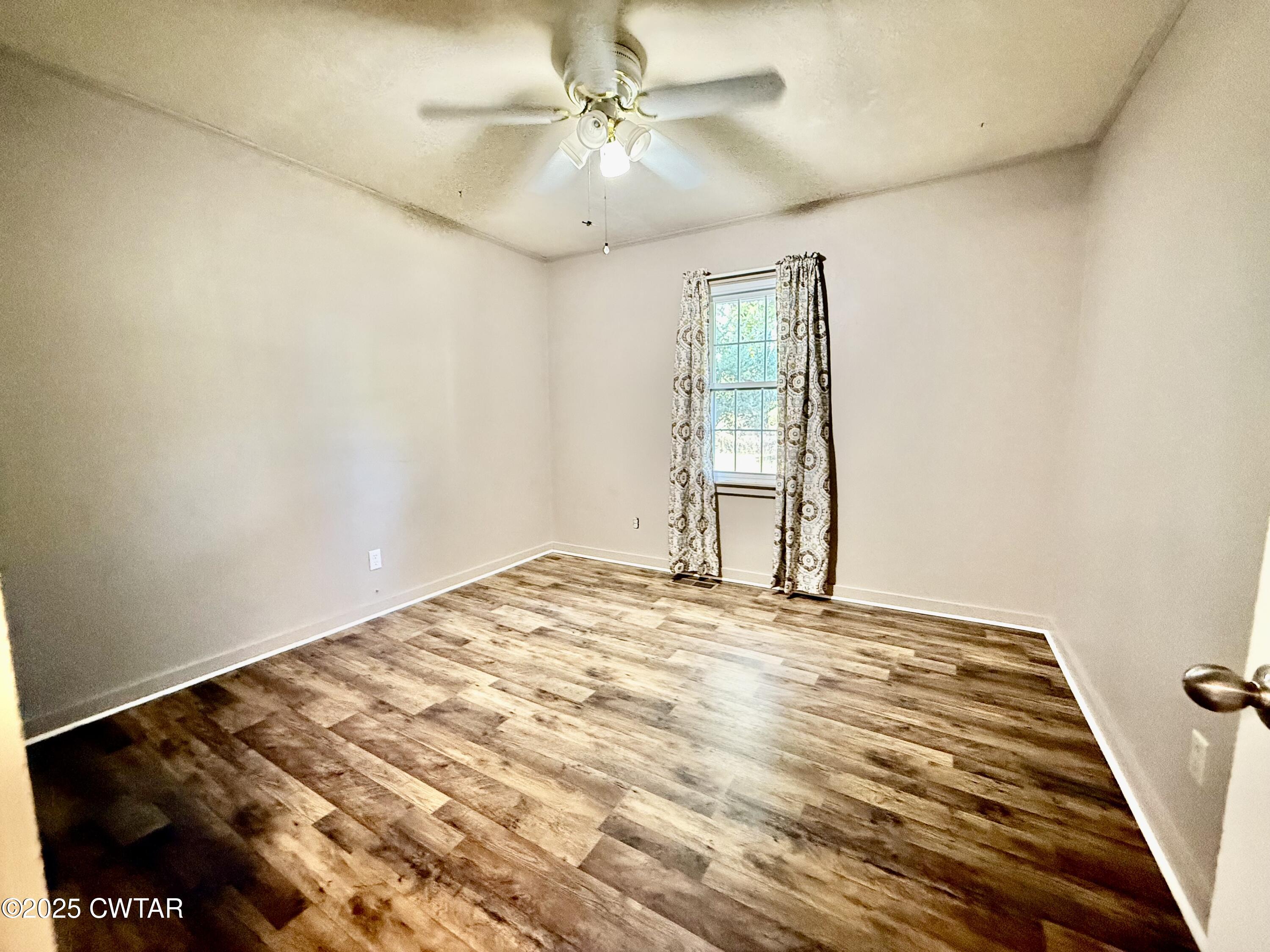 5021 McClard Road Union City, TN 38261 - Photo 13 of 21 a view of a big room with windows and chandelier fan