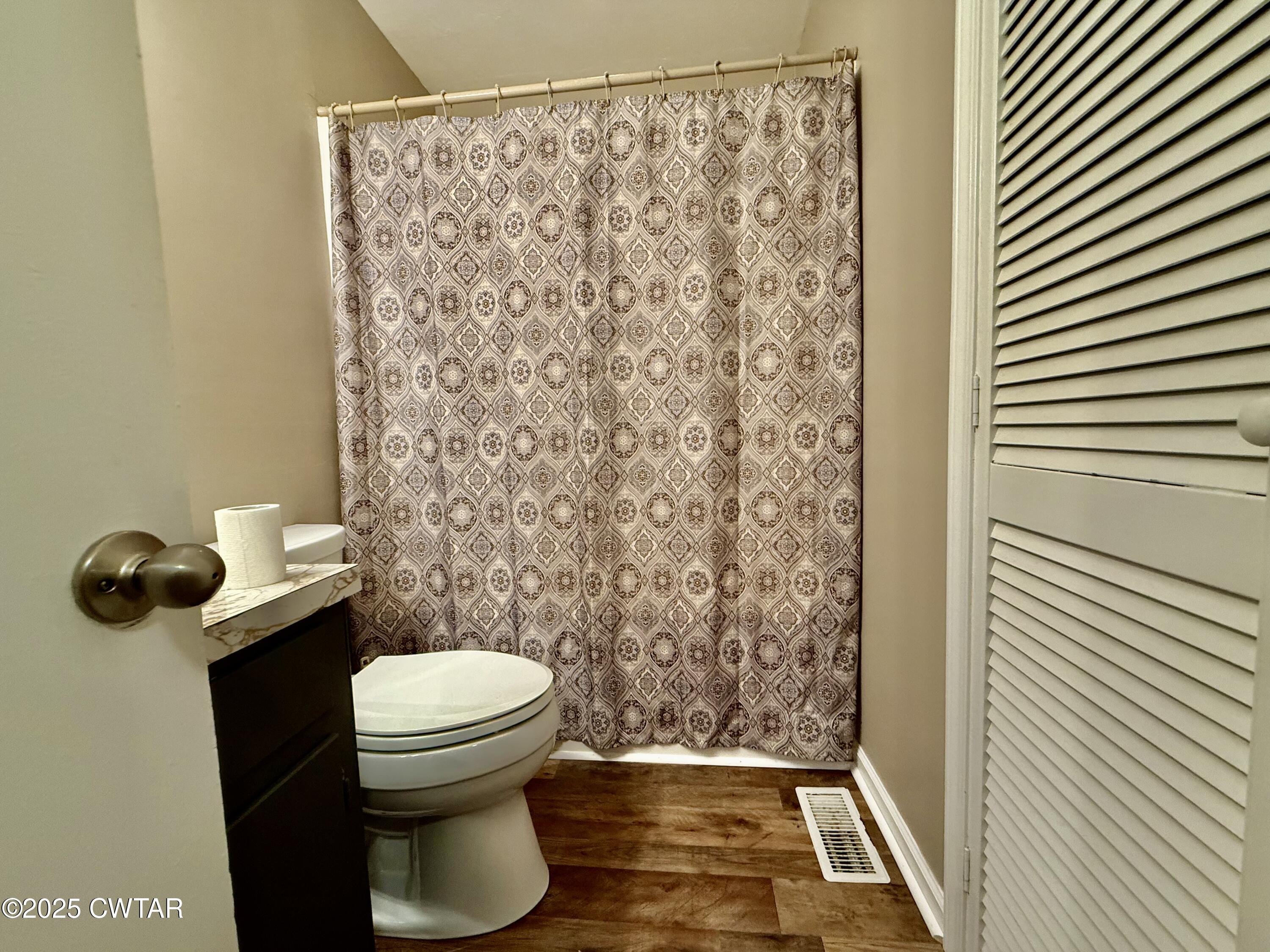 5021 McClard Road Union City, TN 38261 - Photo 16 of 21 a bathroom with a toilet and a shower curtain
