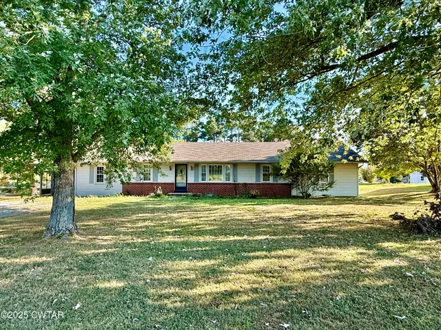 a yellow house in middle of a forest