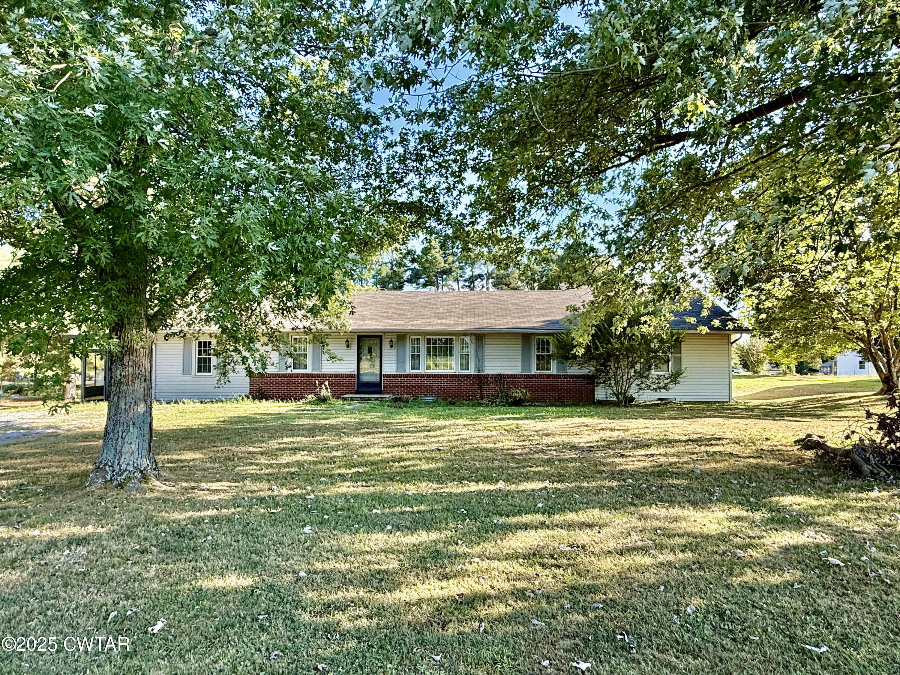 5021 McClard Road Union City, TN 38261 - Photo 21 of 21 a yellow house in middle of a forest
