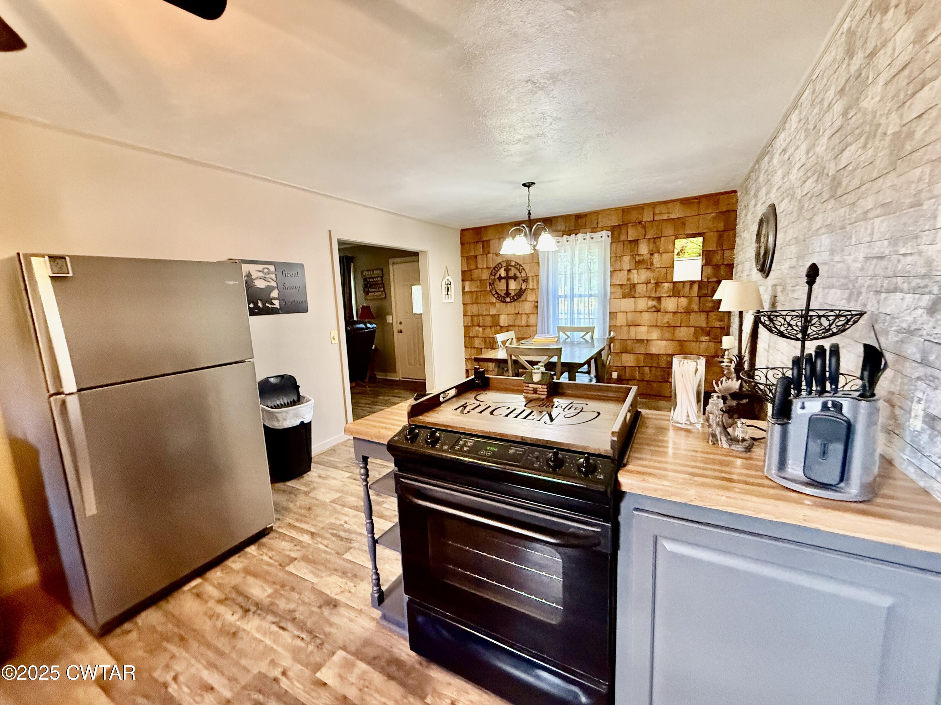 5021 McClard Road Union City, TN 38261 - Photo 6 of 21 a kitchen with a stove a refrigerator and a view of living room