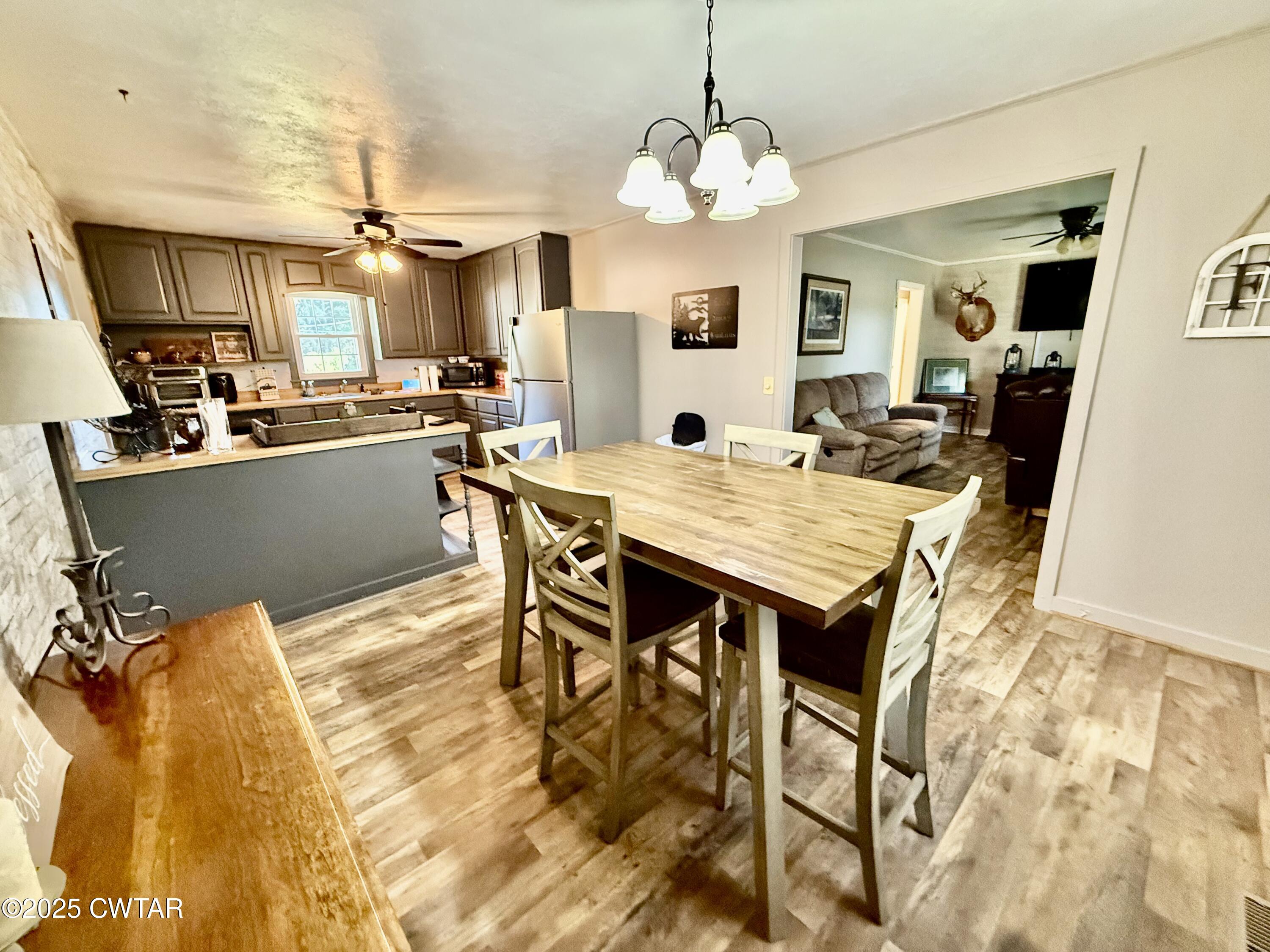 5021 McClard Road Union City, TN 38261 - Photo 7 of 21 a view of a dining room with furniture and a chandelier