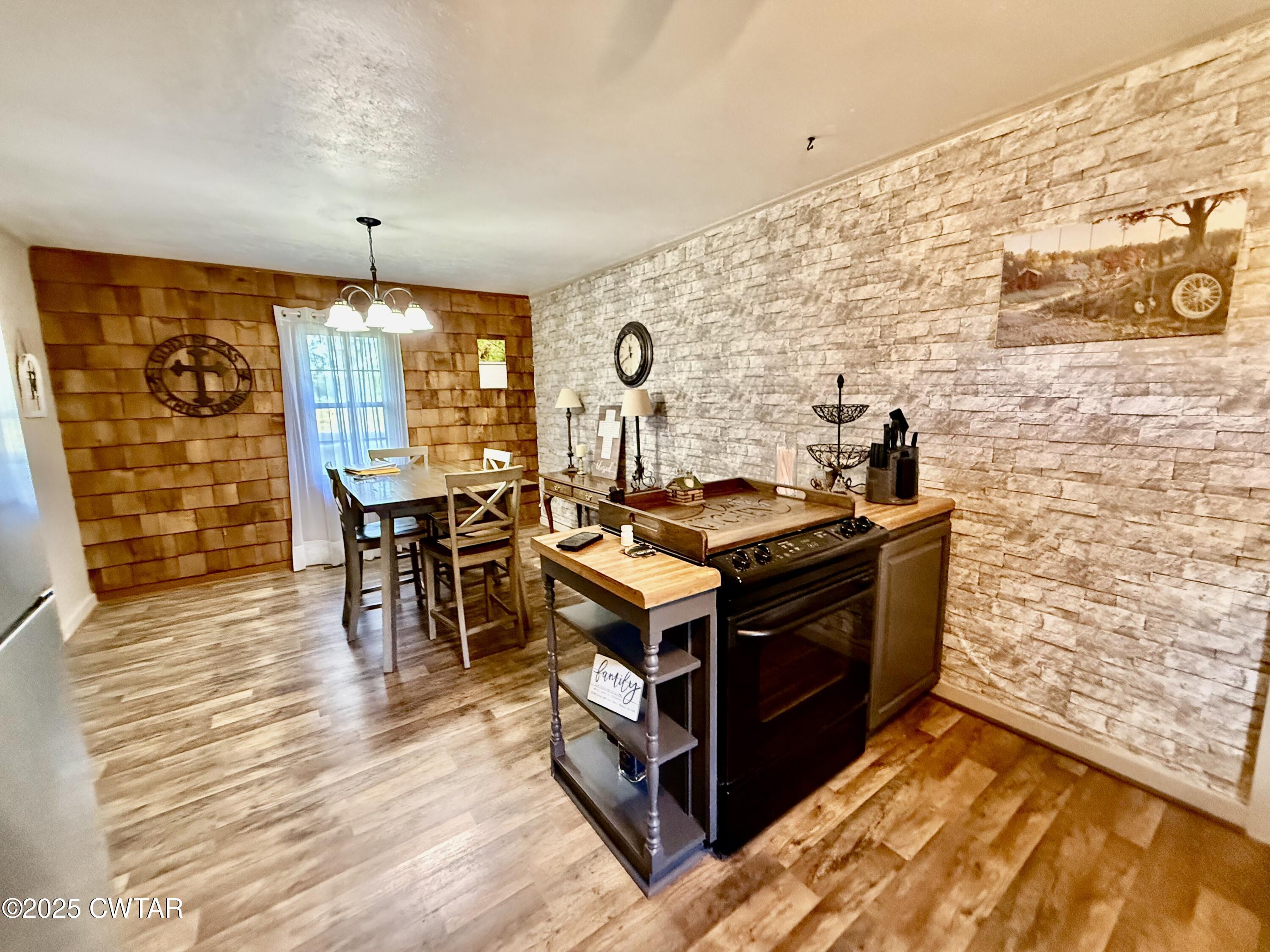 5021 McClard Road Union City, TN 38261 - Photo 8 of 21 a kitchen with stainless steel appliances granite countertop a stove and a wooden floors