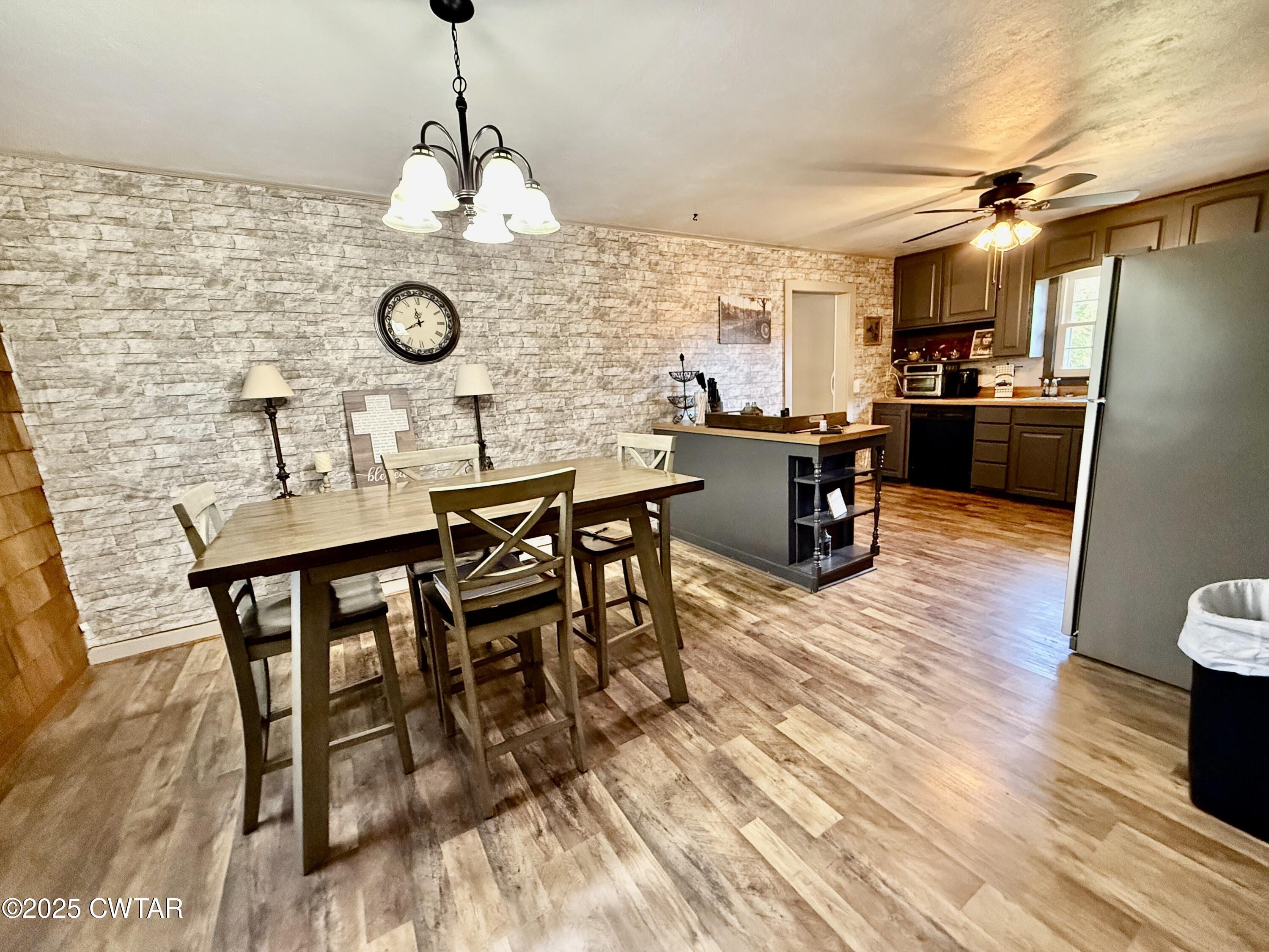5021 McClard Road Union City, TN 38261 - Photo 10 of 21 a view of a dining room with furniture and wooden floor