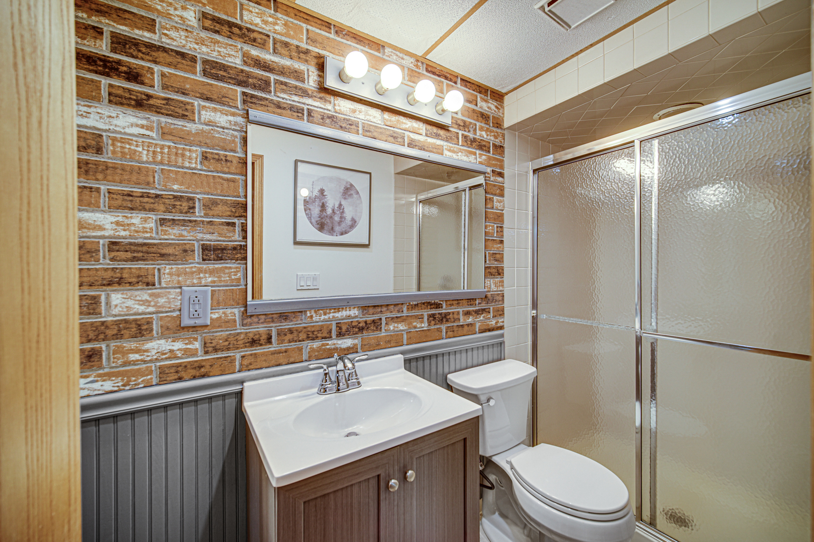 807 Summit Avenue Wauconda, IL 60084 - Photo 22 of 25 a bathroom with a sink a toilet a mirror and shower