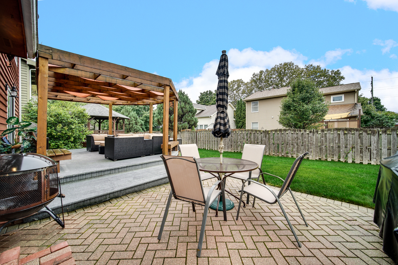 807 Summit Avenue Wauconda, IL 60084 - Photo 23 of 25 a view of a patio with table and chairs potted plants with wooden fence