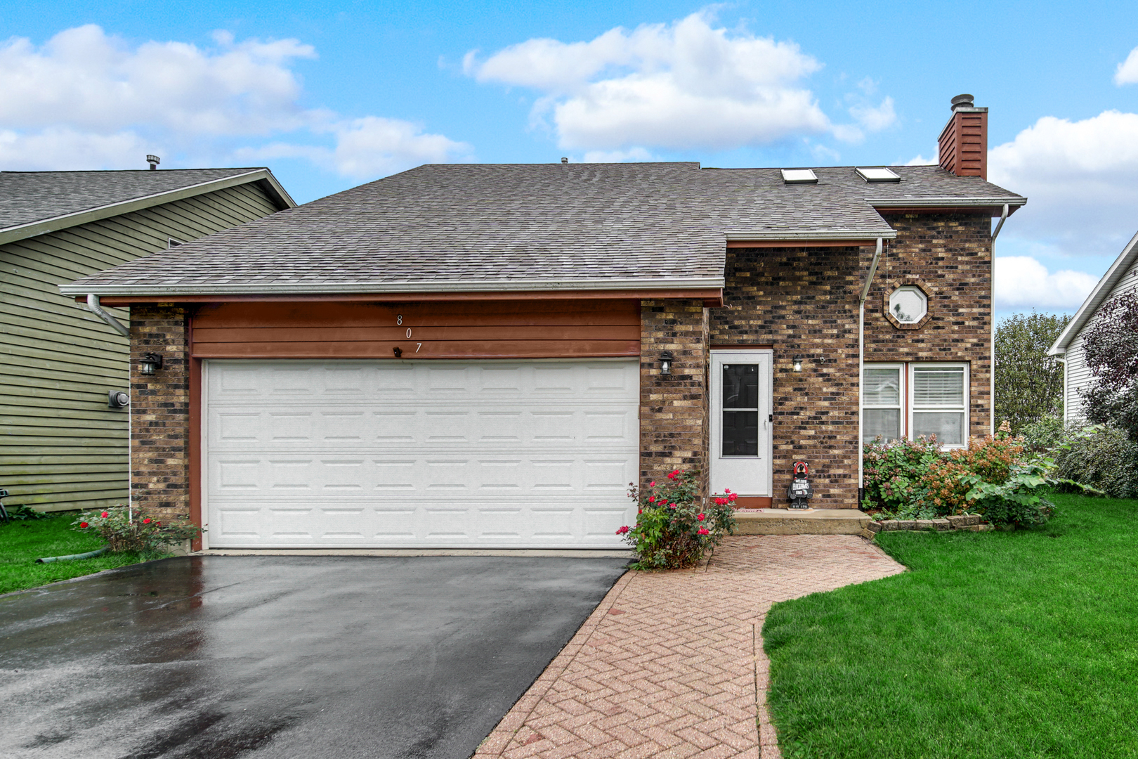 807 Summit Avenue Wauconda, IL 60084 - Photo 3 of 25 a front view of a house with a yard and garage