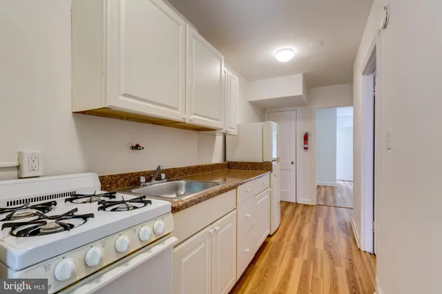 a kitchen with granite countertop a stove and a sink