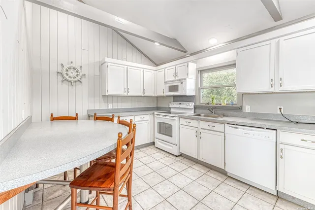 a kitchen with stainless steel appliances granite countertop a stove a sink dishwasher and a refrigerator