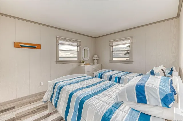 a bedroom with two beds and a window