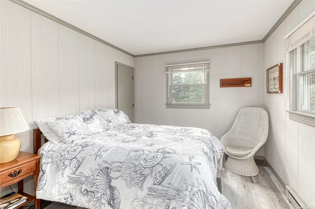 a bed sitting in a bedroom next to a window