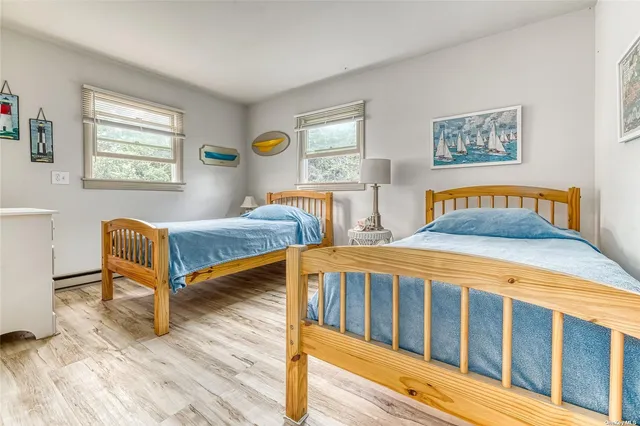 a bedroom with two beds and a window