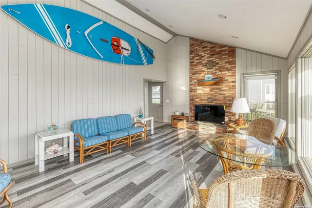 a living room with furniture a rug and a fireplace