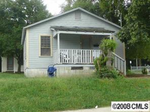 a view of a house with a yard patio and a garden