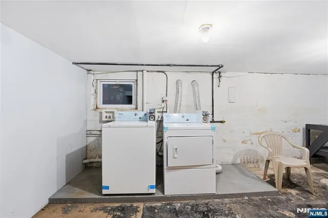 a utility room with cabinets washer and dryer