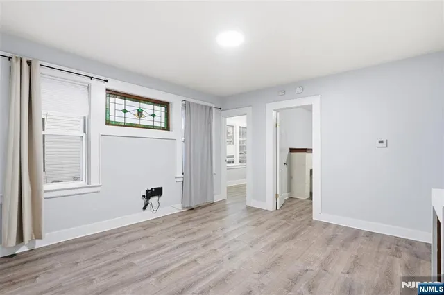 an empty room with windows and closet