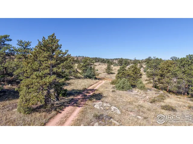 a open area with mountains in the background