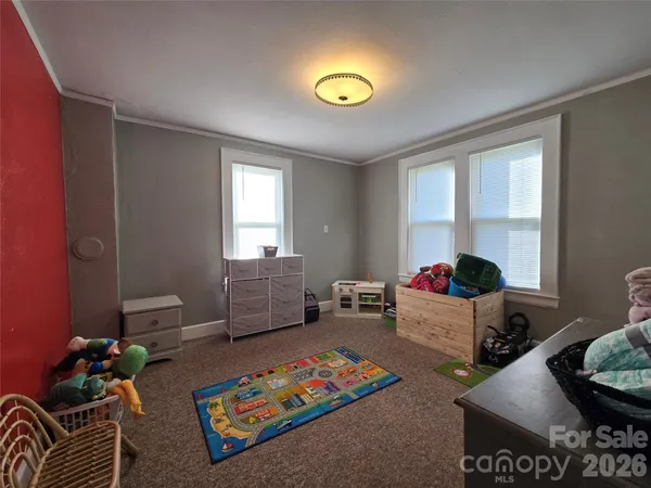 a bed room with furniture and a window