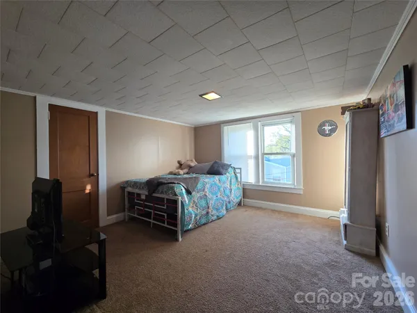 a bedroom with a bed and flat screen tv