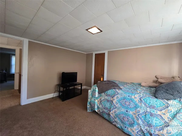 a room with gym equipment and a rug