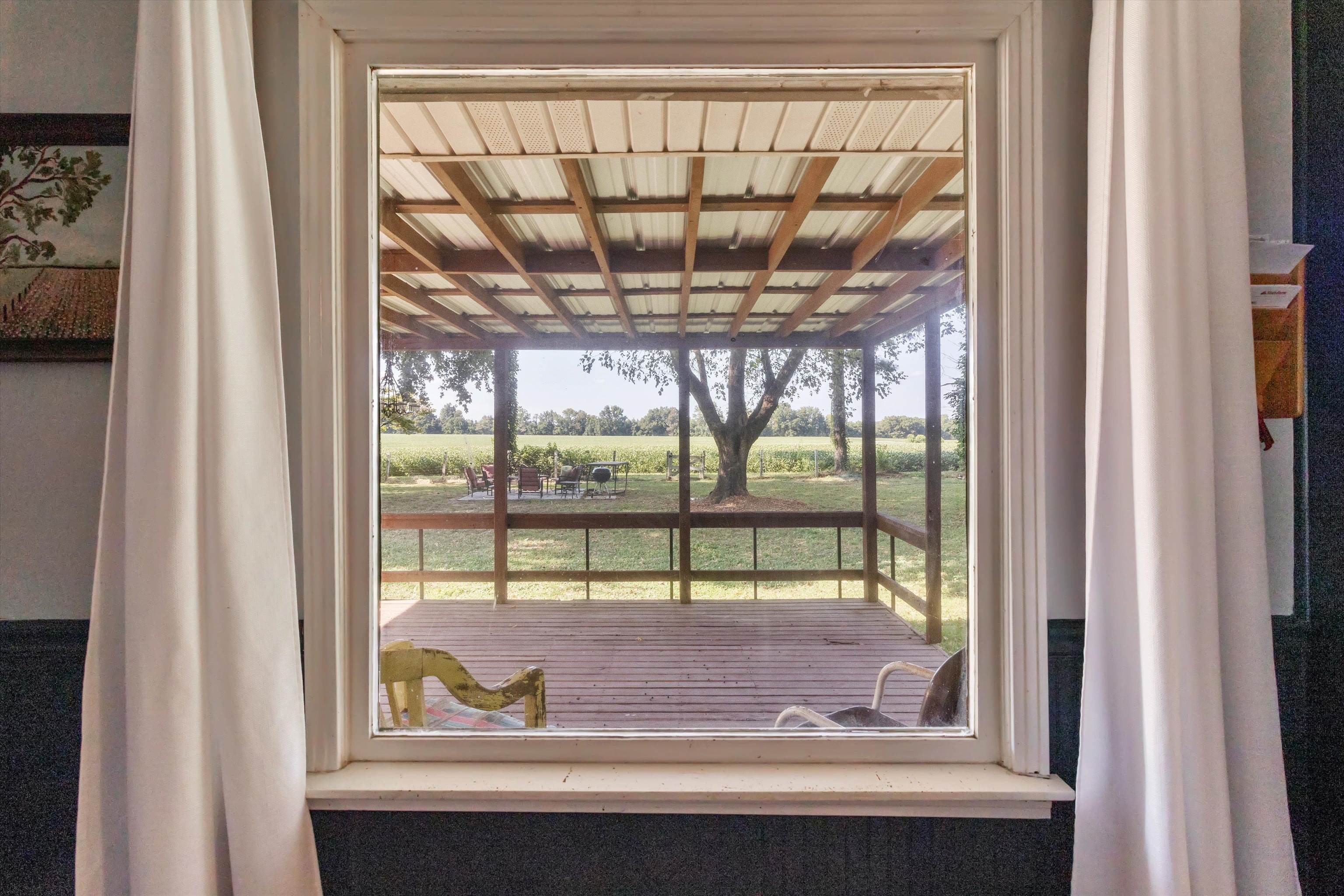 202 Holly Grove Road Covington, TN 38019 - Photo 14 of 32 Area off of kitchen with separate doorway to exterior featuring healthy amount of natural light and a view of countryside.