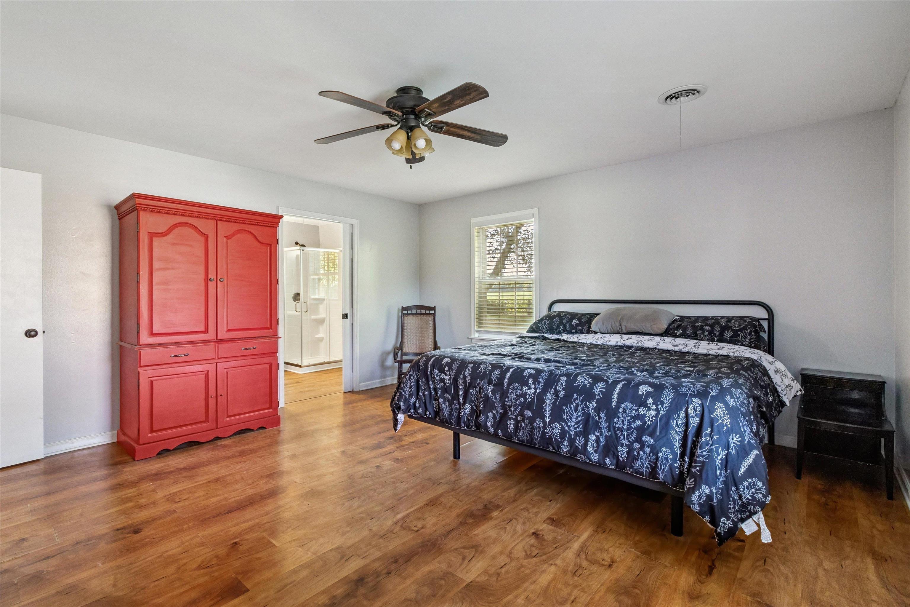 202 Holly Grove Road Covington, TN 38019 - Photo 19 of 32 Bedroom featuring wood finished floors and ceiling fan