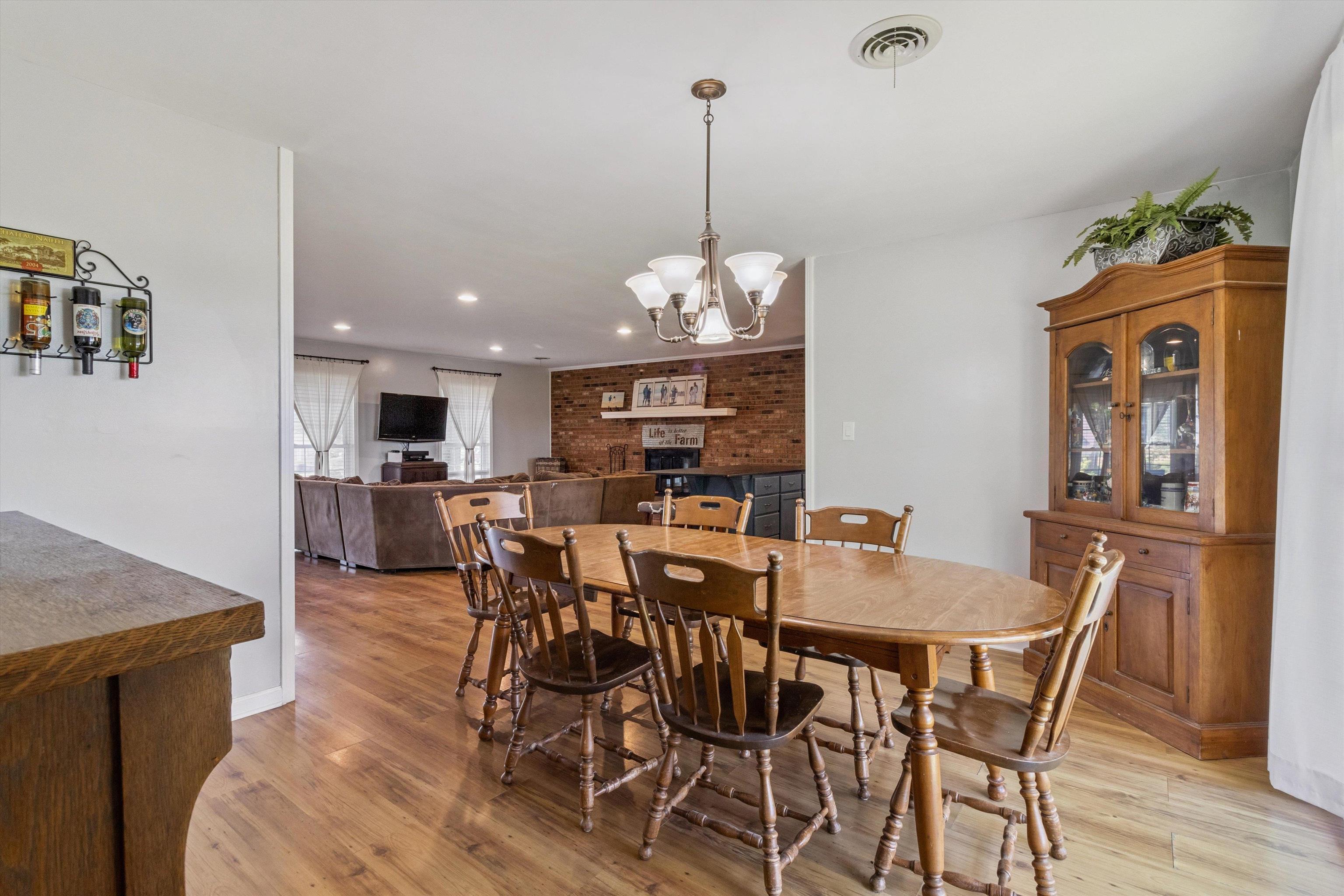 202 Holly Grove Road Covington, TN 38019 - Photo 8 of 32 Dining room with light wood-style flooring, a chandelier, and recessed lighting