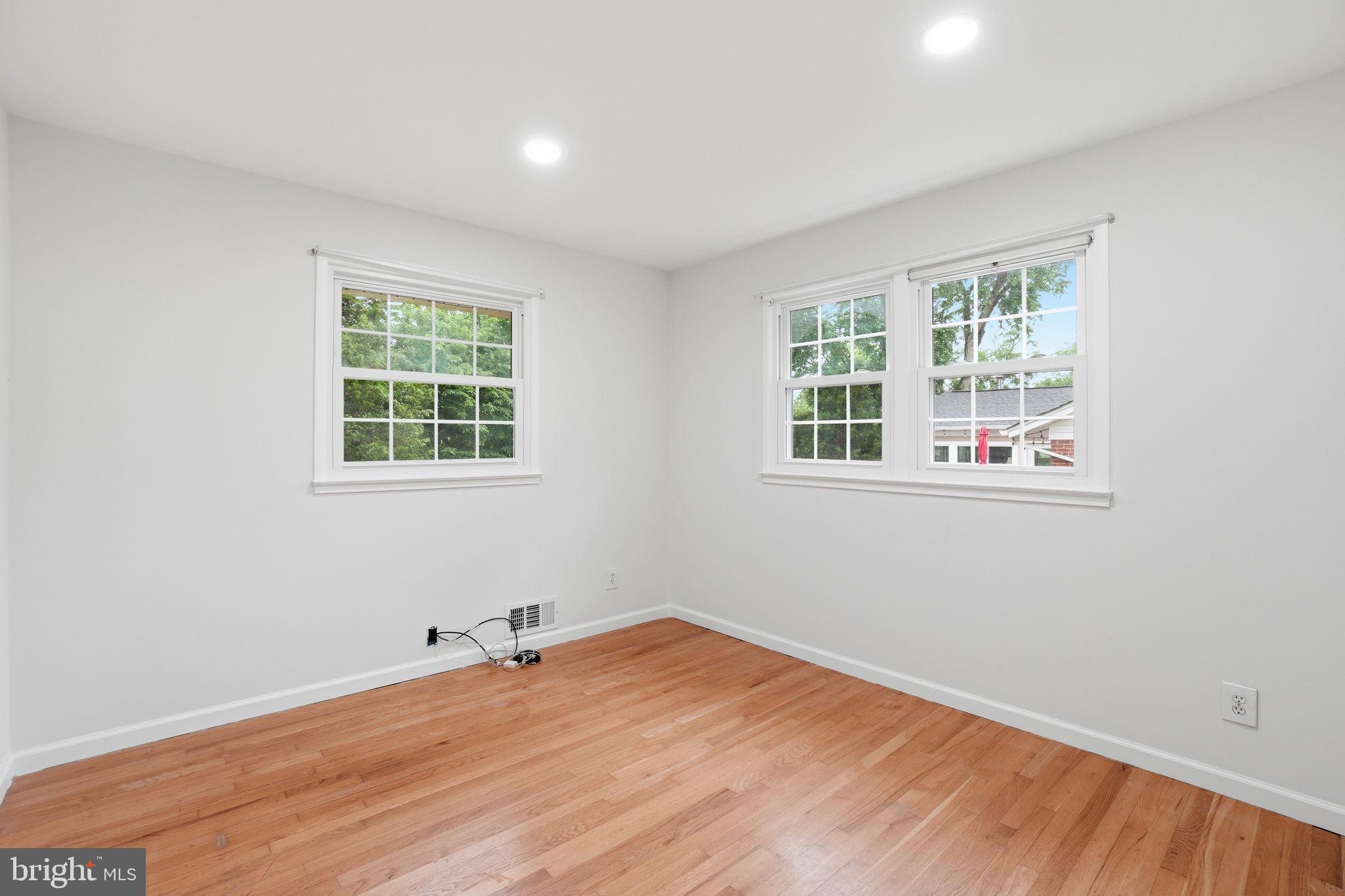 5304 Pillow Lane Springfield, VA 22151 - Photo 13 of 32 an empty room with wooden floor and windows