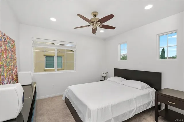 a bedroom with a large bed and a window