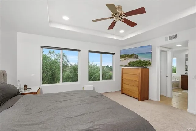a view of a livingroom with furniture a ceiling fan and window