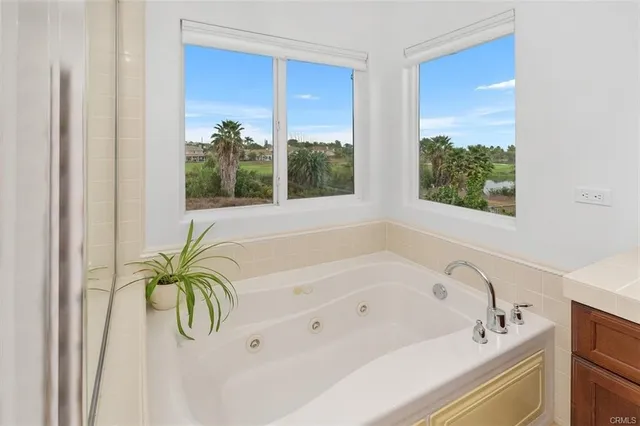 a bath tub sitting in a bathroom next to a window