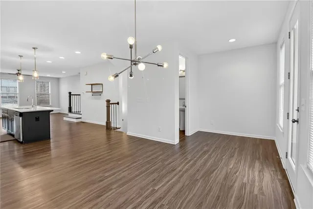 a kitchen with stainless steel appliances granite countertop a refrigerator and a stove