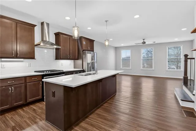 a view of kitchen dining table wooden floor and an entryway