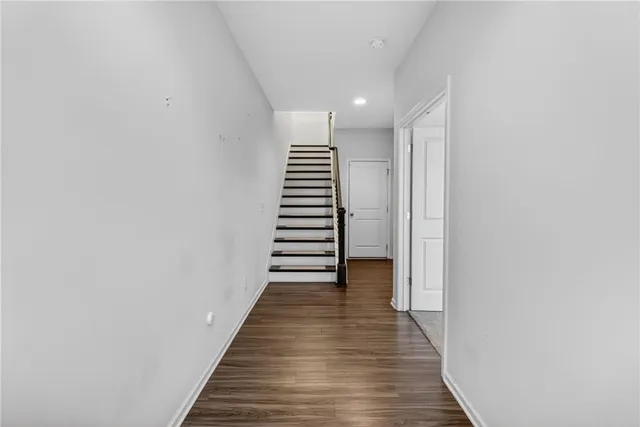 a view of a hallway with wooden floor