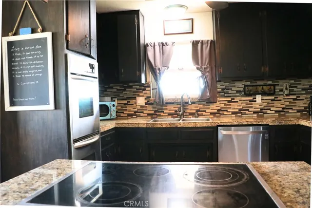 a kitchen with a sink and a refrigerator