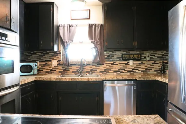 a kitchen with a sink and a refrigerator