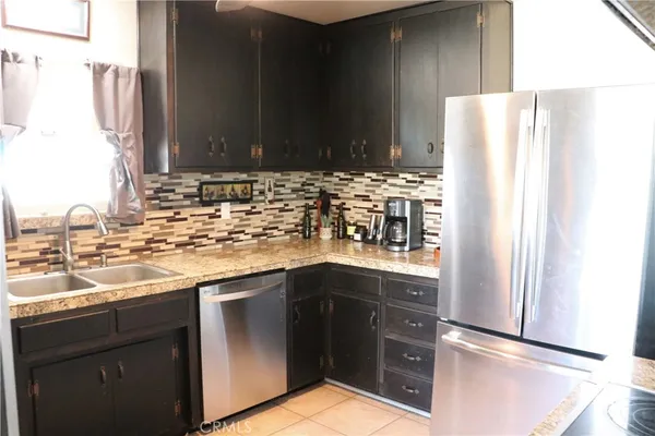 a kitchen with a sink and a refrigerator