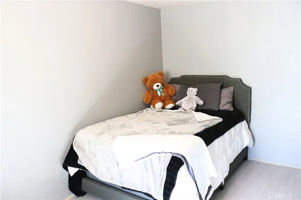 a bed sitting in a bedroom next to a window