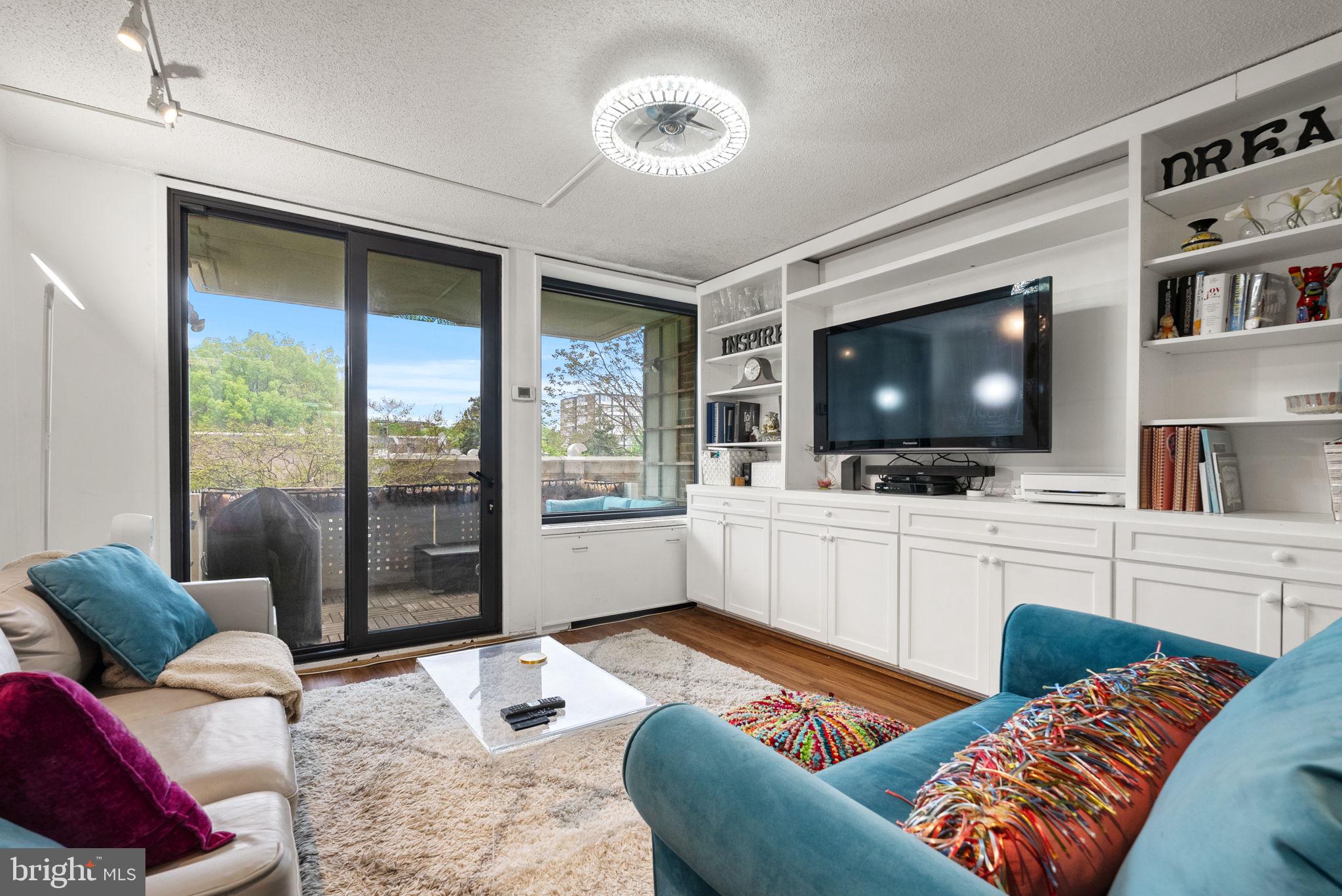 1250 4th Street Southwest, Unit W107 Washington, DC 20024 - Photo 11 of 30 a living room with furniture and a flat screen tv