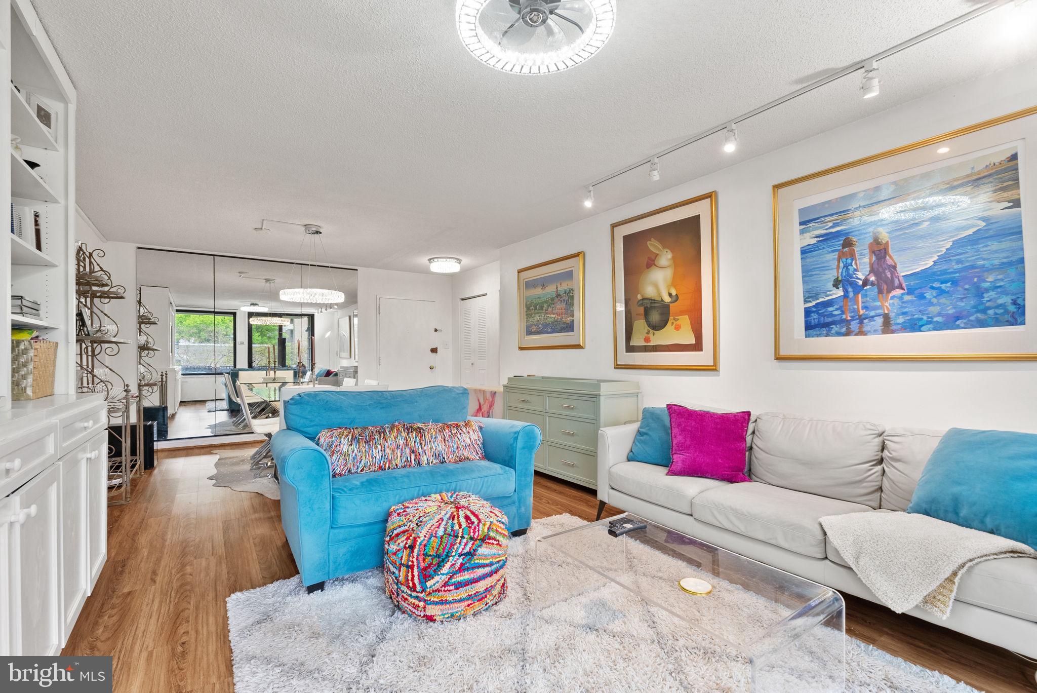 1250 4th Street Southwest, Unit W107 Washington, DC 20024 - Photo 13 of 30 a living room with furniture and a wooden floor