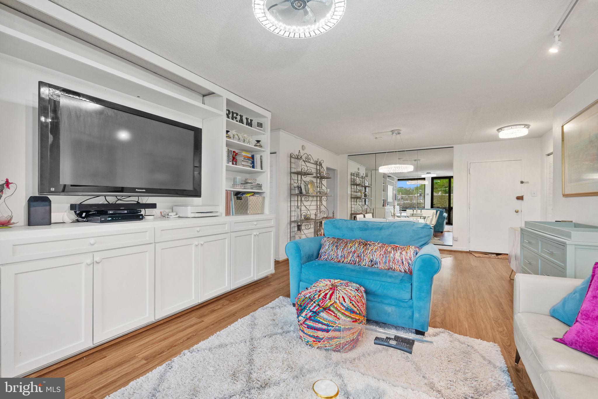 1250 4th Street Southwest, Unit W107 Washington, DC 20024 - Photo 14 of 30 a living room with furniture and a flat screen tv