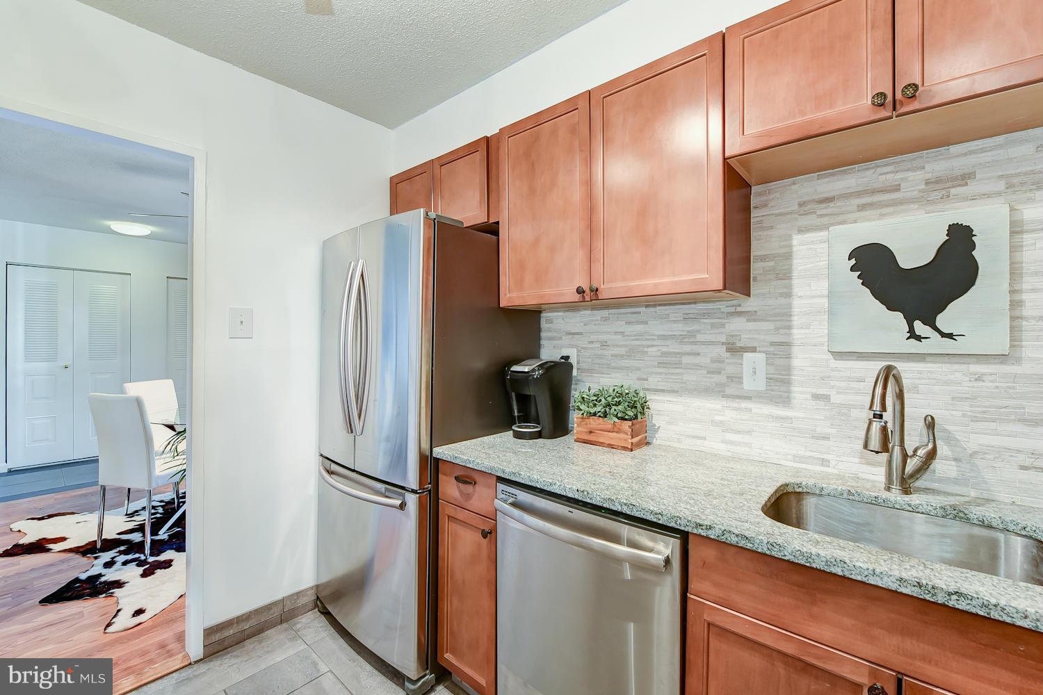 1250 4th Street Southwest, Unit W107 Washington, DC 20024 - Photo 17 of 30 a kitchen with stainless steel appliances granite countertop a refrigerator and a sink