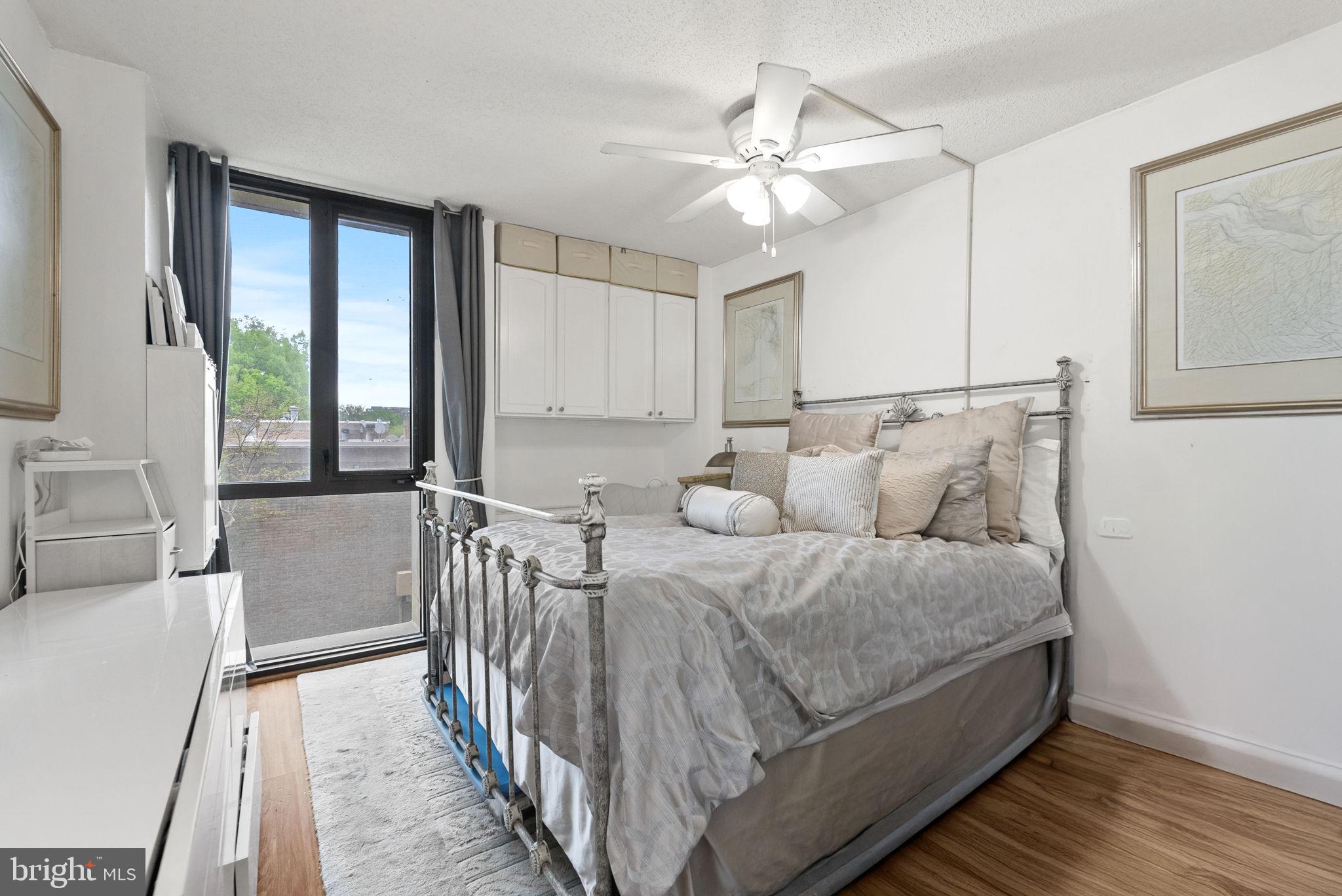 1250 4th Street Southwest, Unit W107 Washington, DC 20024 - Photo 19 of 30 a bed room with a bed and a chandelier